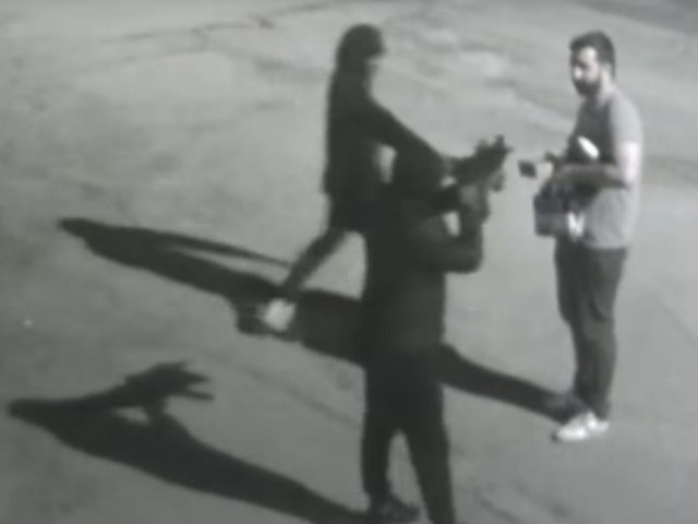 Security cameras captured the moment two armed robbers ordered a victim to the ground at g