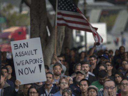 A sign calling for a ban on assault type weapons is held at a vigil for the worst mass shooing in United States history on June 13, 2016 in Los Angeles, United States. A gunman killed 49 people and wounded 53 others at a gay nightclub in Orlando, Florida early …