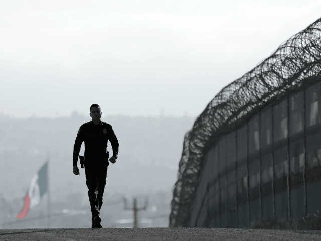 In this Wednesday, June 22, 2016 photo, Border Patrol agent Eduardo Olmos walks near the s