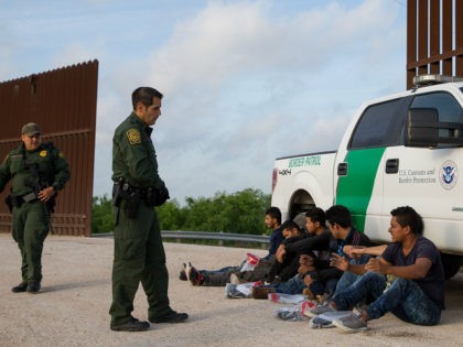 Border Patrol agents apprehend illegal immigrants shortly after they crossed the border from Mexico into the United States on Monday, March 26, 2018 in the Rio Grande Valley Sector near McAllen, Texas. An estimated 11 million undocumented immigrants live in the United States, many of them Mexicans or from other …