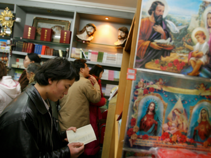 Chinese Catholics shop for bibles after midnight Christmas mass at a government approved C