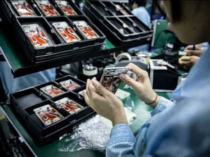 An employee assembles a OnePlus X smartphone at the OnePlus manufacturing facility in Dong