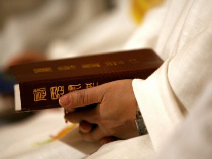 A worshiper holding a chinese bible