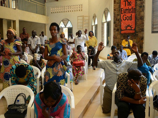 People pray inside an Evangelical restoration church on April 6, 2014, in Kigali, on the e