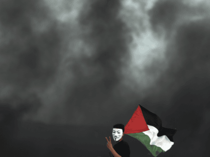 A protester holding a Palestinian flag flashes the victory sign for a photographer during a protest at the Gaza Strip border with Israel, in eastern Gaza City, Wednesday, April 4, 2018. A leading Israel human rights group urged Israeli forces in a rare step Wednesday to disobey open-fire orders unless …