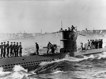 (Original Caption) 11/10/1939-Kiel, Germany: One of Germany's undersea commerce raiders is shown, crew lined up on the decks and officers in the conning tower, as it arrived at the German Naval base at Kiel after a cruise. The German caption calls it 'one of our victorius U-boats.'