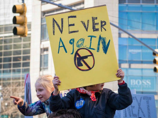 View of a young demonstrator, on someone's shoulders, as she holds a sign that reads 'Neve