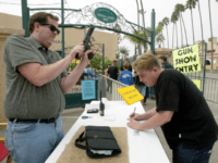 gun show A man checks a handgun at the reception desk of the Cross Roads of the West Gun Show in Del Mar, California, 20 October, 2002, where loade guns are not allowed. The show is being held several times a year in dozens of cities in the West Coast and gathers …