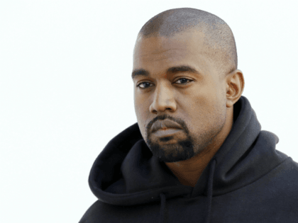 American rapper Kanye West poses before Christian Dior 2015-2016 fall/winter ready-to-wear