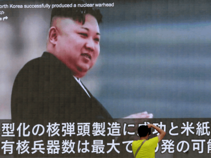 In this Aug. 6, 2017, file photo, a man takes a photo of a TV news program in Tokyo, showing an image of North Korean leader Kim Jong Un. The U.S. intelligence agencies’ assessments of the size of North Korea’s nuclear arsenal have a wide gap between high and low …