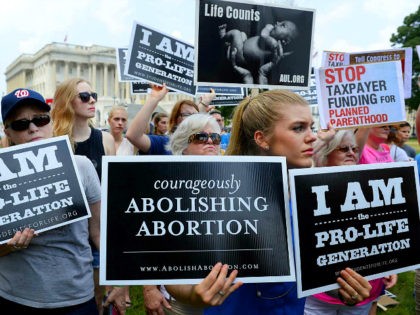 WASHINGTON, DC - JULY 28: Anti-abortion activists hold a rally opposing federal funding for Planned Parenthood in front of the U.S. Capitol on July 28, 2015 in Washington, DC. Sen. Rand Paul (R-KY) announced a Senate deal to vote on legislation to defund Planned Parenthood before the Senate goes into …