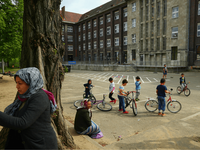 BERLIN, GERMANY - MAY 03: Residents of a shelter for refugees and migrants in Marienfelde district relax in the courtyard of the shelter, which was previously an administrative building for a supermarket chain, on May 3, 2017 in Berlin, Germany. The shelter currently houses approximately 450 people, the majority of …