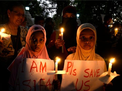 KOLKATA, WEST BENGAL, INDIA - 2018/04/17: Muslim girl holds the candle and poster along wi