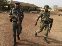 Policemen patrol at the internally displaced people camp occupied largely by women and children affected by herders and farmer's violent clashes from Logo and Guma communities at Gbajimba IDPs camp on the outskirts of Makurdi, capital of Benue State in northcentral Nigeria on January 3, 2018. Nomadic cattle herders have …