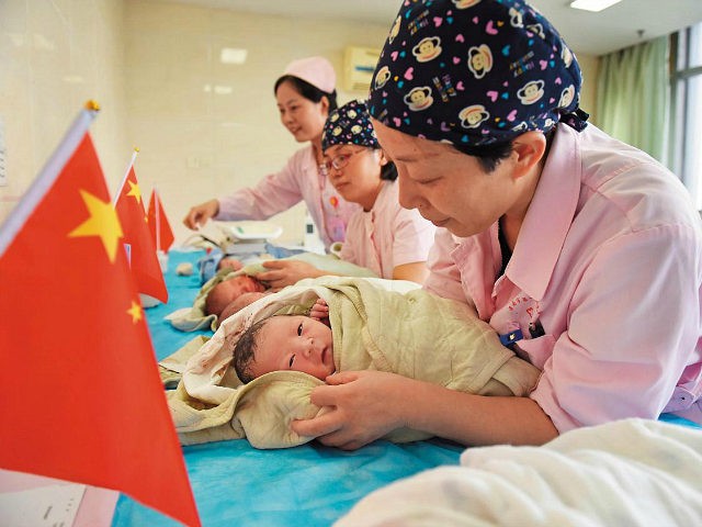 HUAINAN, CHINA - OCTOBER 01: Nurses take care of babies who were born on the National Day