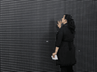 opiod Janine Fisher of Pittsburgh looks at an art installation called "Prescribed to Death Memorial" at the William Pitt Union at the University of Pittsburgh on Wednesday, Jan. 31, 2018 in Pittsburgh. The installation features 22,000 carved medicine pills that represent the face of someone who fatally overdosed in 2015. A …