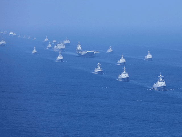 In this April 12, 2018 photo released by the Xinhua News Agency, the Liaoning aircraft carrier is accompanied by Navy frigates and submarines conducting exercises in the South China Sea.  China has announced live-fire military exercises in the Taiwan Strait amid heightened tensions over increased US support for Taiwan.  The announcement by authorities in coastal Fujian Province on Thursday was accompanied by a statement that the navy would end a three-day exercise in southern China a day earlier.  (Li Gang / Xinhua via AP)