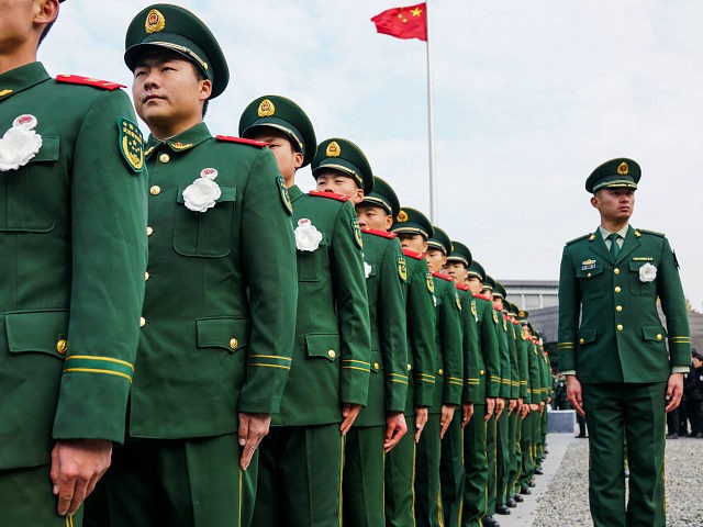 People's Liberation Army (PLA) soldiers participate in a ceremony at the Nanjing Massacre