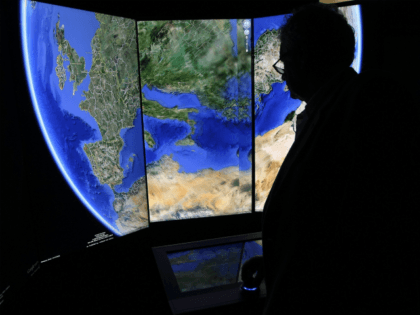 A visitor looks at a three-dimensional rendering of the planet Earth while using Google Earth software on September 26, 2012 at the official opening party of the Google offices in Berlin, Germany. Although the American company holds 95% of the German search engine market share and already has offices in …