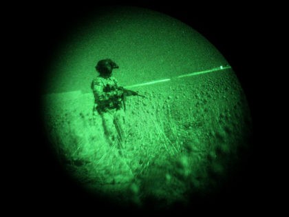 U.S. Army flight crew chief Sgt. Robert Terrants is seen through night vision goggles as he stands in an opium field while waiting to medevac a lightly injured Marine in a helicopter of the U.S. Army's Task Force Lift "Dust Off", Charlie Company 1-214 Aviation Regiment north of Sangin, in …