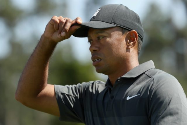 Tiger battles through with clutch shots in Masters return