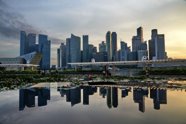 Singapore tightens monetary policy, warns on trade tensions