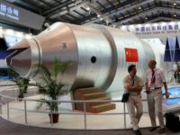 China Defunct Space Station In this Nov. 16, 2010 file photo, visitors sit beside a model of China's Tiangong 1 space station at the 8th China International Aviation and Aerospace Exhibition in Zhuhai in southern China's Guangdong Province. China’s defunct Tiangong 1 space station is expected to re enter Earth’s atmosphere within the next day. The European Space Agency forecast Sunday April 1, 2018 the station will re enter sometime between Sunday night and early Monday morning GMT. (AP Photo/Kin Cheung, File) The Associated Press