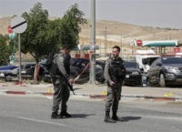 Israel Palestinians Israeli police officers stand guard at the scene where they say a Palestinian tried to stab an Israeli with a long screwdriver and was shot by another Israeli civilian, near the Israeli settlement of Mishor Adumim, in the West Bank, Sunday, April 8, 2018. The incident follows at least 31 Palestinians being shot dead in almost two weeks of protests along the Gaza border. (AP Photo/Mahmoud Illean) Israel strikes Gaza after explosive devices found on border