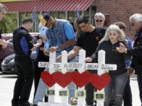 Waffle House Shooting Family members of people killed at a Waffle House restaurant write messages on wooden crosses set up as a memorial Wednesday, April 25, 2018, in Nashville, Tenn. Four people were killed when a gunman opened fire at the restaurant Sunday. Members of the Waffle House management and staff joined the family members as the restaurant re opened Wednesday. (AP Photo/Mark Humphrey) The Associated Press