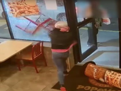 A woman smashed the front window of a Popeyes restaurant, reportedly because she wasn't given a soda with her Wicked Good Deal.
