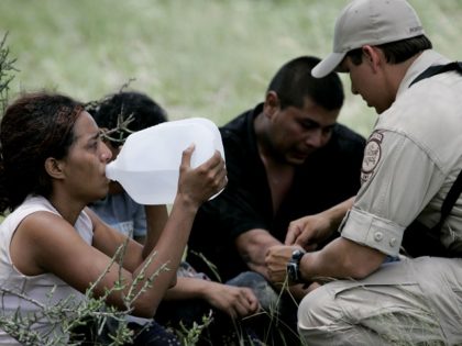 Border Patrol agent Isaac David, right, talks with illegal immigrants stopped on a ranch near Falfurrias, Texas, Wednesday, July 5, 2006. David is part of the Border Patrol's Search, Trauma and Rescue team, known as Borstar, he is part of an elite force that can track someone with a faxed …