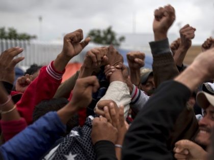 Migrant Caravan members celebrate after hearing that fellow members were allowed to enter the U.S. (AP Photo/Hans-Maximo Musielik)