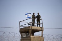 Israeli soldiers guard on top of a watch tower in a community along the Israel- Gaza Strip Border, Tuesday, May 15, 2018. Thousands joined funeral processions Tuesday for some of the dozens of Palestinians killed by Israeli troops in a mass march on the Gaza border, as Israelis faced growing …