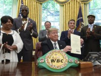 President Donald Trump center, posthumous pardons Jack Johnson, boxing's first black heavyweight champion, during an event in the Oval Office of the White House in Washington, Thursday, May 24, 2018. Trump is joined by, from left, Linda Haywood, who is Johnson's great-great niece, heavyweight champion Deontay Wilder, Keith Frankel, Sylvester …