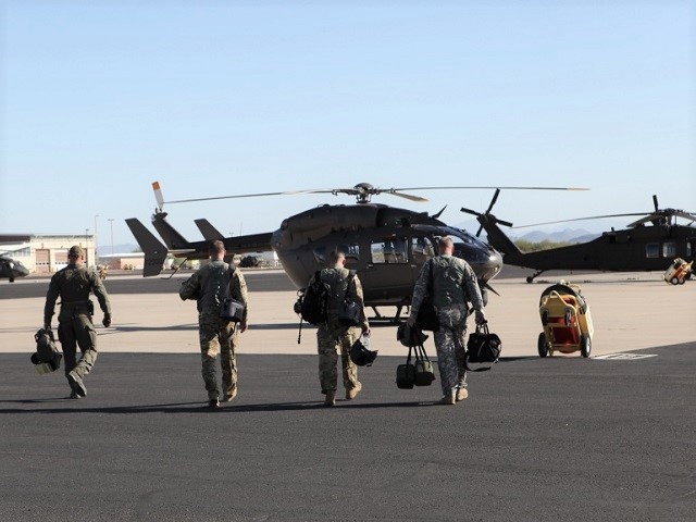 Chief Warrant Officer Andrew Ottinger, Chief Warrant Officer Weston Holtmeyer, and Sgt. Brent Woods of the Missouri National Guard, teams up with Border Patrol Agent Zachary Pruett of Tucson Sector’s Mobile Response Team as they prepare for the first aviation support mission for Operation Guardian Support. (Photo: Lu Maheda - U.S. Customs and Border Protection)
