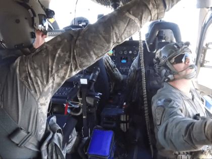 Chief Warrant Officer Weston Holtmeyer (front left), Chief Warrant Officer Andrew Ottinger (front right) and Sergeant Brent Woods (left rear) of the Missouri National Guard, along with BPA Zachary Pruett (left rear) of Tucson Sector’s Mobile Response Team, conduct aerial surveillance near Tucson, AZ as part of the first operational …