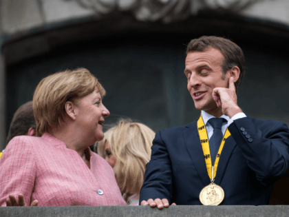German Chancellor Angela Merkel (L-R) and French President Emmanuel Macron gesture on the balcony of the town hall of Aachen after Macron recieved the International Charlemagne Prize at a ceremony on May 10, 2018 in Aachen, Germany.