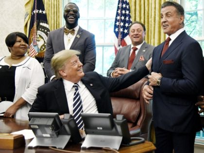US President Donald Trump acknowledges actor Sylvester Stallone after signing an Executive