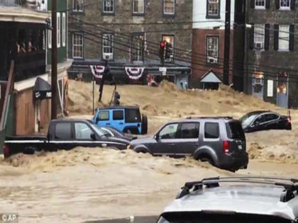 Water rushes through Main Street in Ellicott City, Md., Sunday, May 27, 2018. Flash flooding and water rescues are being reported in Maryland as heavy rain soaks much of the state. (Libby Solomon/The Baltimore Sun via AP)