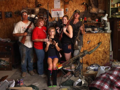 LOGAN, KS - AUGUST 24: The Becker family, including Darren, his wife Dorthy and their children Renee 15, Katie, 17 and Charlie, 19, show off a small part of the family weapons collection, and their pet Mini Chihuahua, at the Becker farm August 24, 2012 in Logan, Kansas.