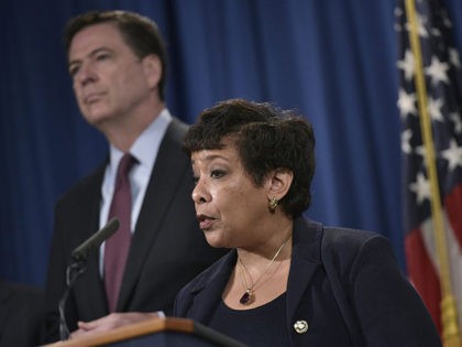 US Attorney General Loretta Lynch (C) speaks during a press conference at the Department of Justice on March 24, 2016 in Washington, DC. At left is FBI Director James Comey. Lynch announced the unsealing of an indictment of seven Iranians on computer hacking charges. / AFP / Mandel Ngan (Photo …