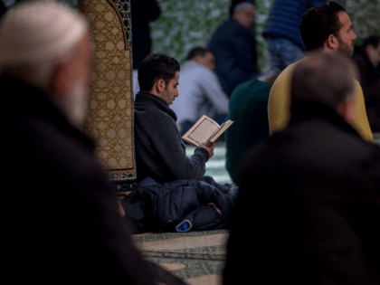 A Muslim man reads from the Koran at the Grand Mosque in Brussels on Match 25, 2016, as Muslims gathered for the first Friday prayers in the wake of the suicide attacks at Brussels airport and a metro station that left 31 people dead and 300 wounded and were claimed …