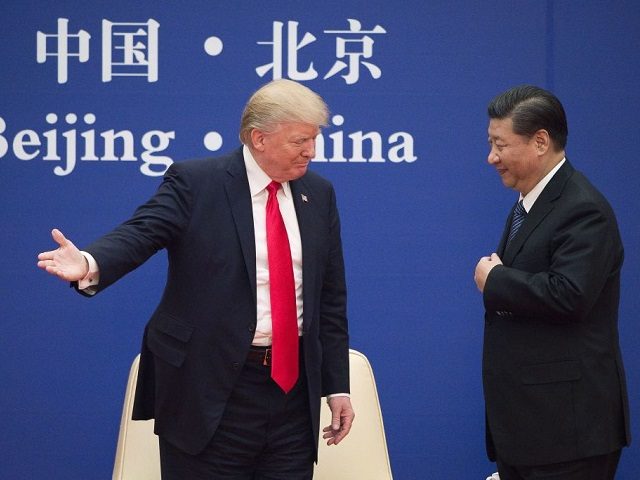 TOPSHOT - US President Donald Trump (L) gestures next to China's President Xi Jinping during a business leaders event at the Great Hall of the People in Beijing on November 9, 2017. Donald Trump urged Chinese leader Xi Jinping to work "hard" and act fast to help resolve the North …