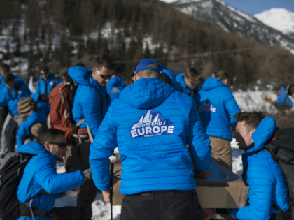Activists from the French far-right political movement Generation Identitaire (GI) and European anti-migrant group Defend Europe carry supplies during an operation titled 'Mission Alpes' to control access of migrants using the Col de l'Echelle mountain pass on April 21, 2018 in Nevache, near Briancon, on the French-Italian border. - A …