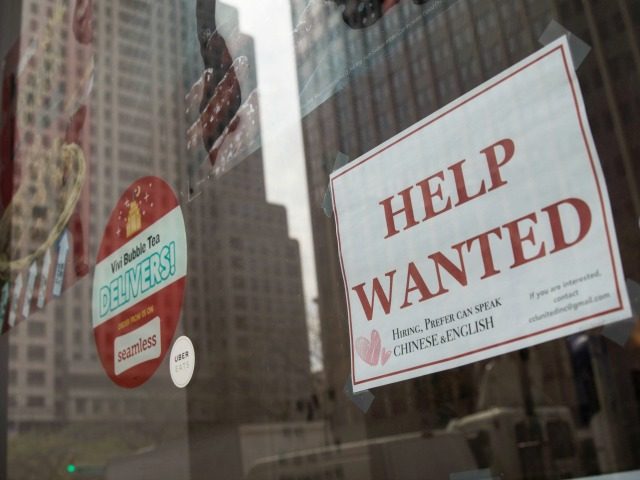 A "help wanted" sign hangs on a window of a restaurant in Lower Manhattan, May 4