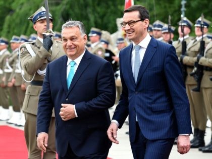 Polish Prime Minister Mateusz Morawiecki and Hungarian Prime Minister Viktor Orban (L) review the honour guard during a welcoming ceremony on May 14, 2018 at the Palace on the Isle in Warsaw's Lazienki Park. (Photo by JANEK SKARZYNSKI / AFP) (Photo credit should read JANEK SKARZYNSKI/AFP/Getty Images)