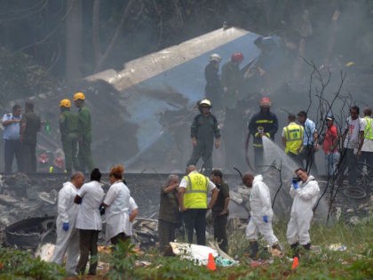 TOPSHOT - Emergency personnel works at the site of the accident after a Cubana de Aviacion