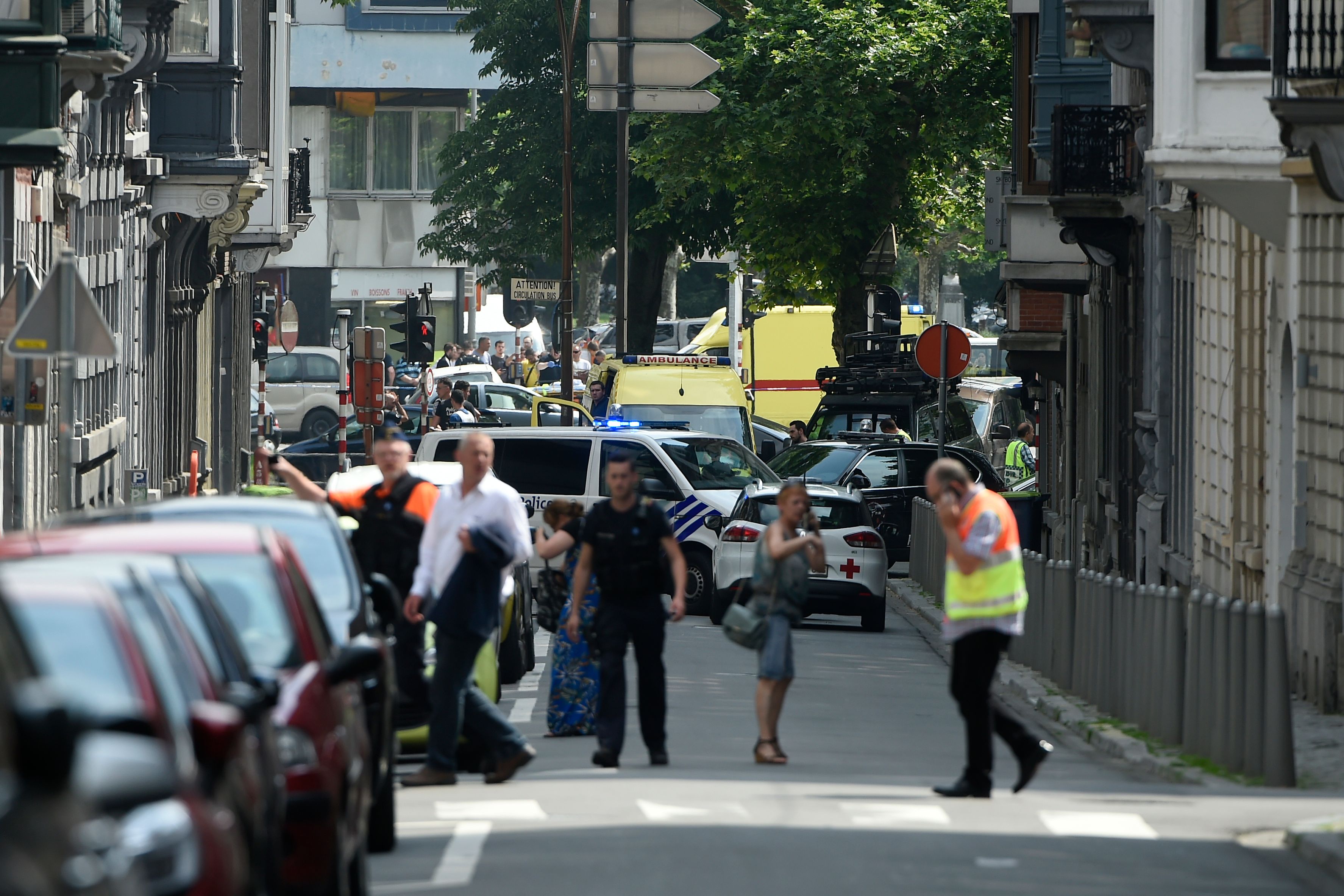 Police and ambulance are seen at the site where a gunman shot dead three people, two of them policemen, before being killed by elite officers, in the eastern Belgian city of Liege on May 29, 2018. - The shooting occurred around 10:30am (0830 GMT) on a major artery in the city close to a high school. "We don't know anything yet," the spokeswoman for the Liege prosecutors office, told AFP when asked about the shooter's motives. (Photo by JOHN THYS / AFP) (Photo credit should read JOHN THYS/AFP/Getty Images)