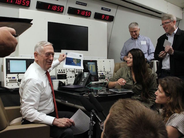 US Defense Secretary Jim Mattis speaks to reporters as he shows the plane's route to Hawaii aboard a US military plane on May 29, 2018. - Mattis vowed the US would continue confronting China over its territorial claims in the South China Sea, where Beijing has established a major military …