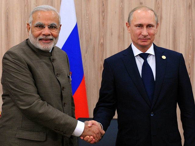 India's Prime Minister Narendra Modi (L) shakes hands with Russia's President Vladimir Put